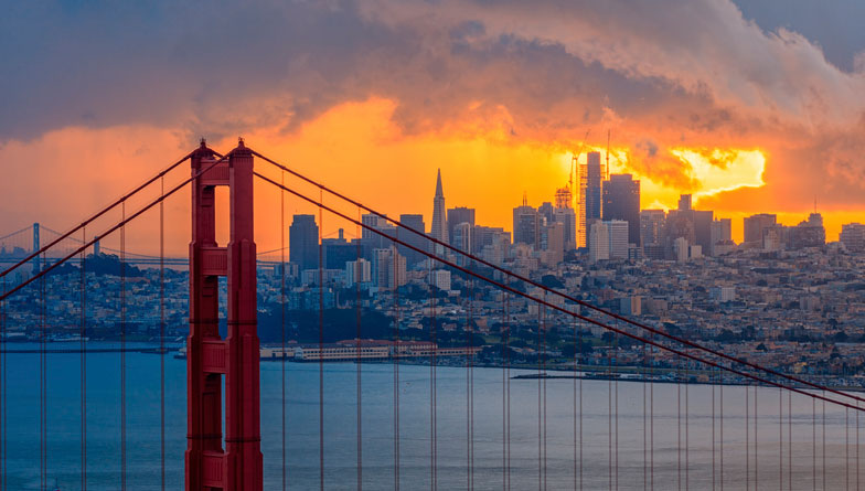 Sunset view of the Golden Gate Bridge with the San Francisco skyline in the background, symbolizing the city's commitment to safety and maintenance, much like the importance of an annual fire sprinkler system inspection.