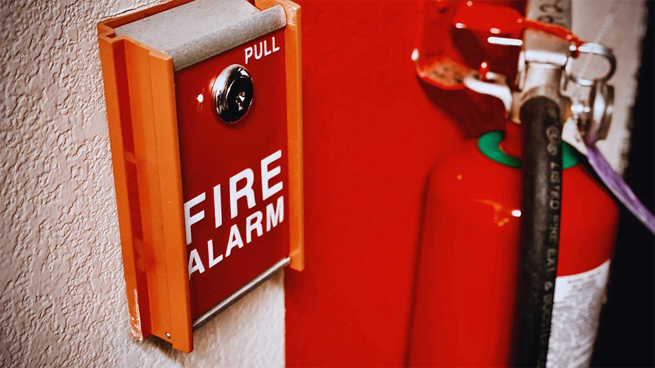 Fire alarm station and extinguisher reviewed during fire alarm inspection in Oakland, CA