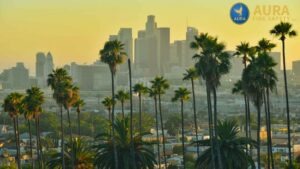 A view of the California skyline in Los Angeles during golden hour. Branded graphic for Aura Fire Safety regarding fire sprinkler inspection non-compliance and fines in California.