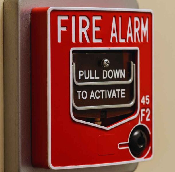 Red fire alarm box mounted on a wall, a crucial component checked during a professional fire alarm inspection in San Leandro, CA